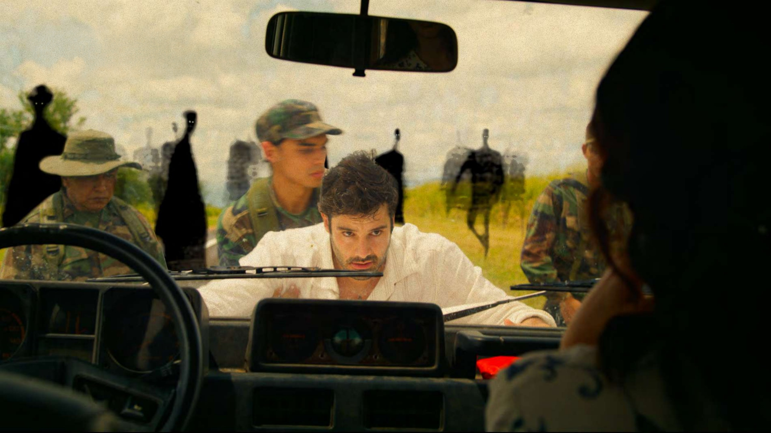 A family seen through the windows of a car on a tense road journey